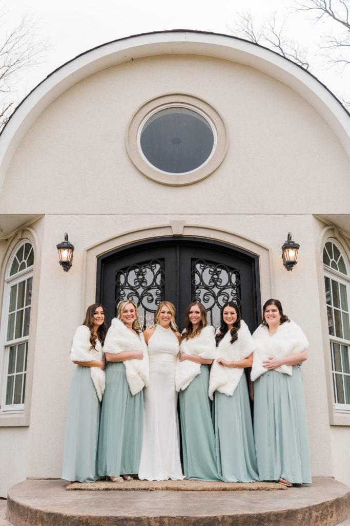 A bride posing with her bridesmaids at Morais Vineyards and Winery