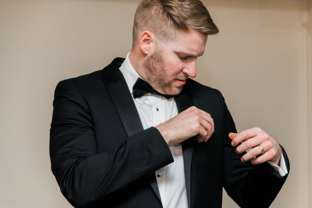 A groom getting ready for his wedding at Morias Vineyards and Winery