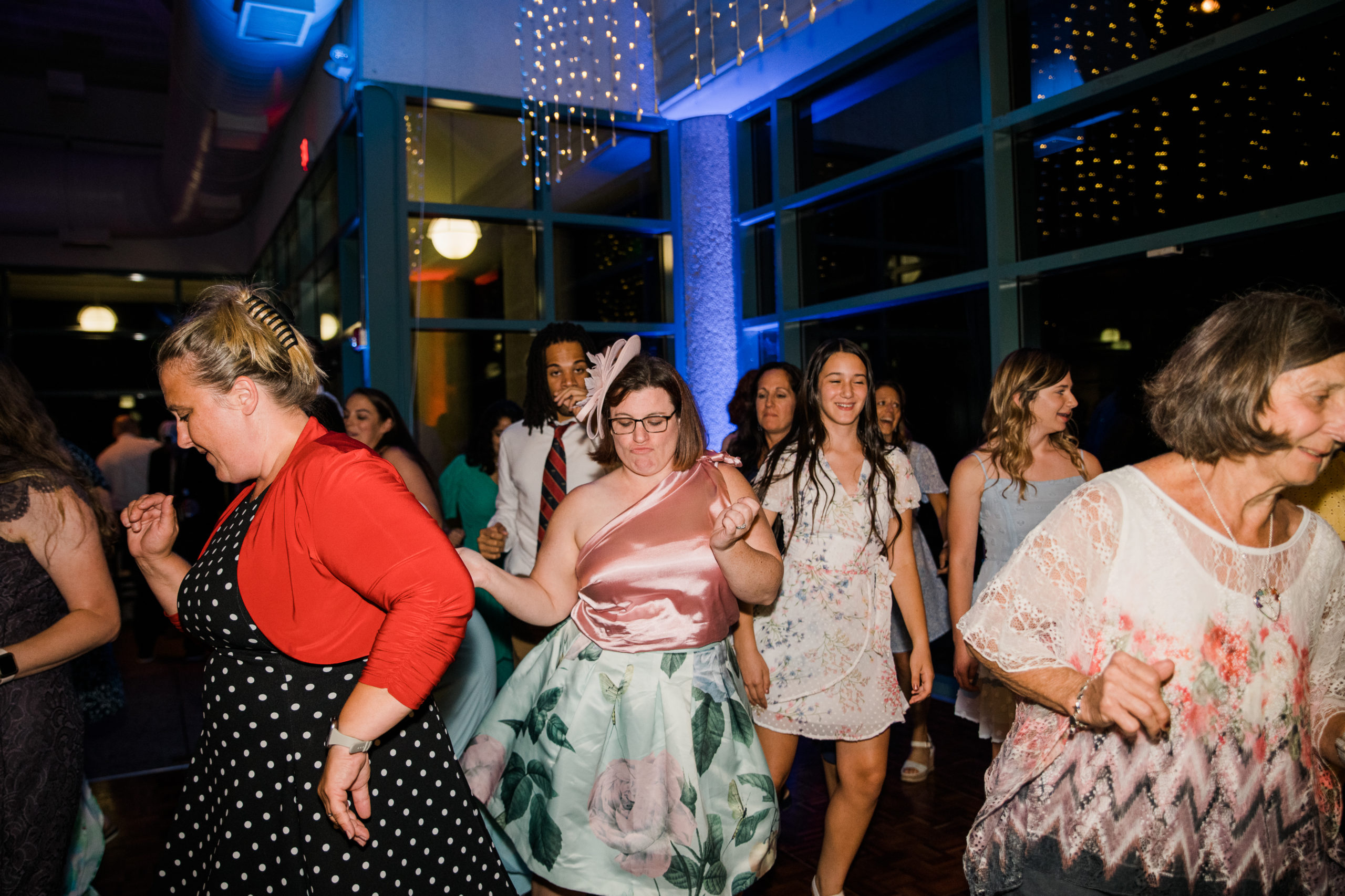 Guests dancing at a wedding reception at the Atrium at Meadowlark Botanical Gardens