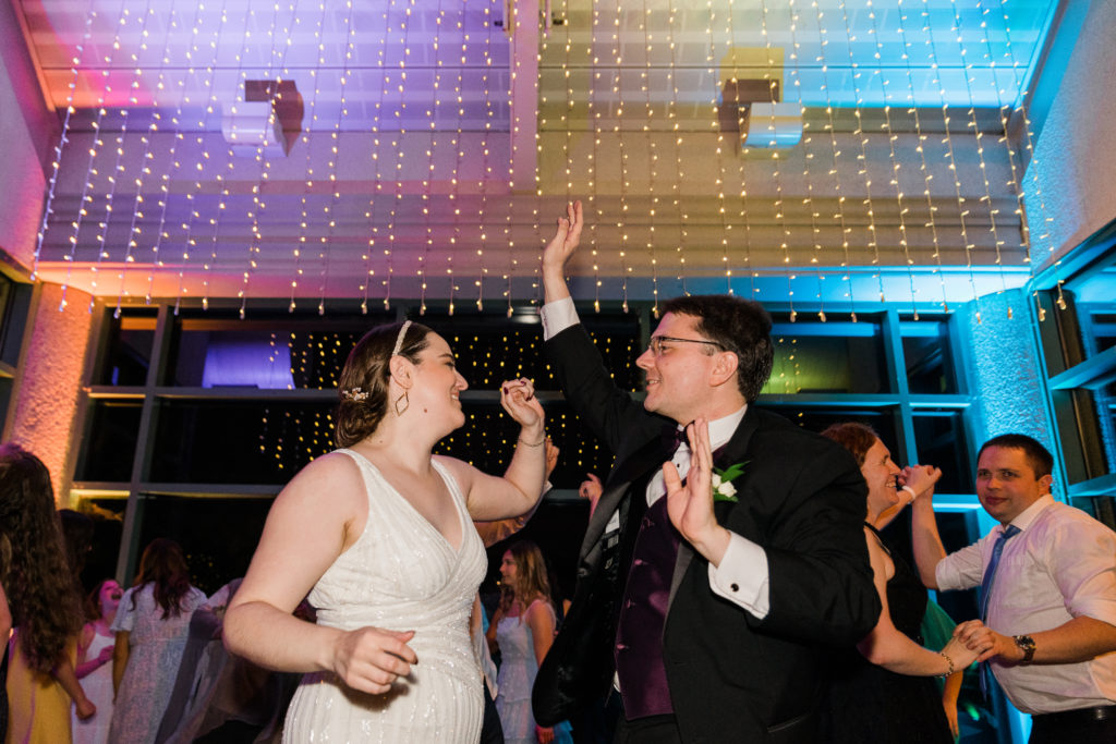 Bride and groom dancing at a wedding reception at the Atrium at Meadowlark Botanical Gardens