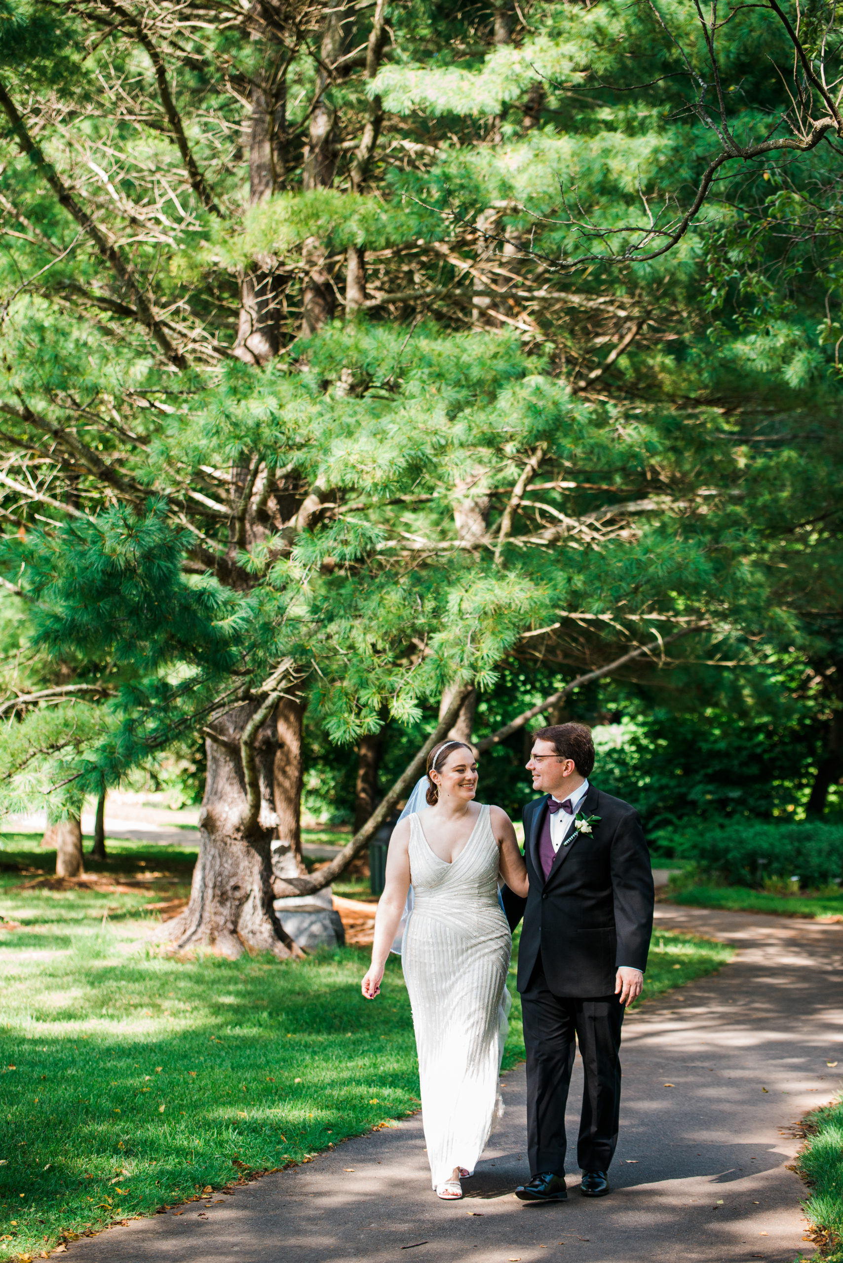 Bride and groom walking hand in hand at the Atrium at Meadowlark Botanical Gardens