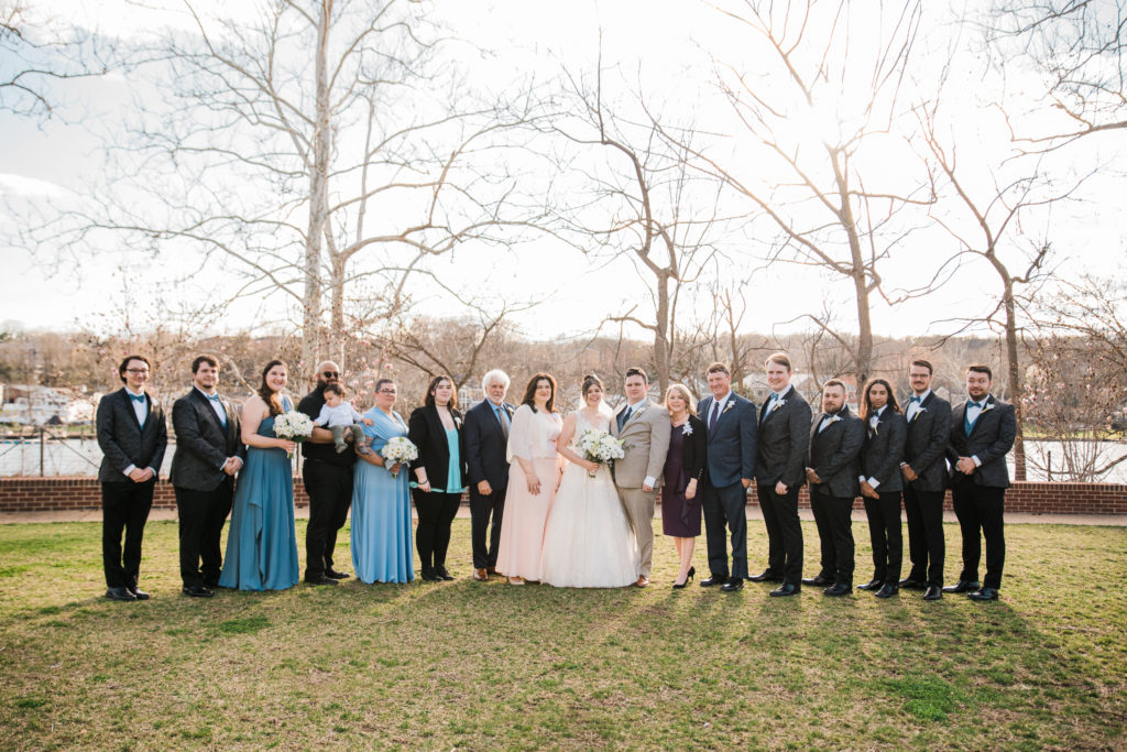 Bride and groom posing with their bridal party at the River View at Occoquan