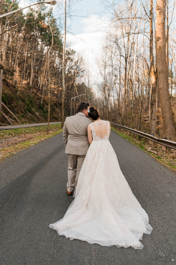 Bride and groom walking down a road at the River View at Occoquan