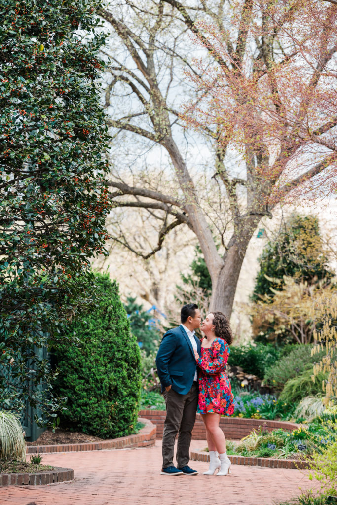 Couple standing in a garden at the Smithsonian Arts and Industries Building