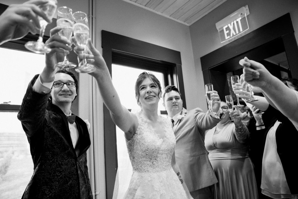 Bride toasting with guests at a wedding reception at the River View at Occoquan