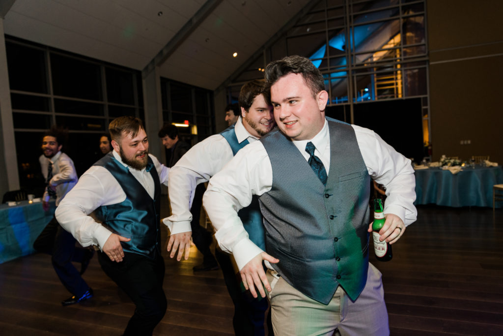 Groom dancing with wedding guests at the River View at Occoquan