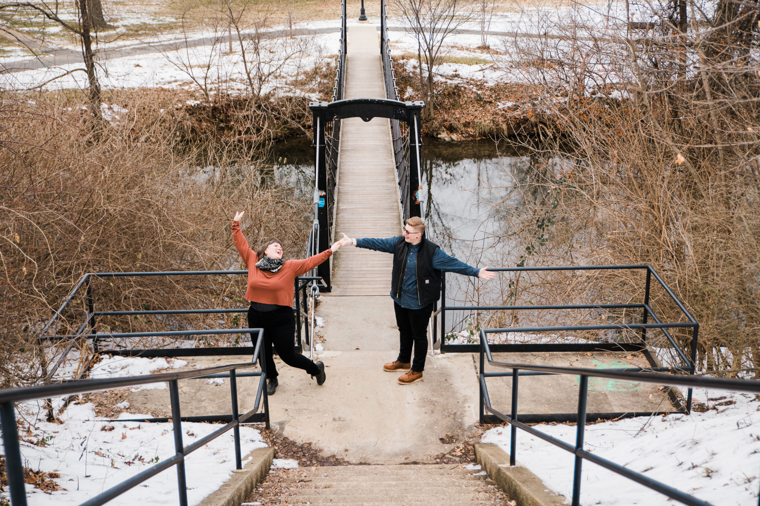 A couple posing outside on a bridge in Frederick  Maryland