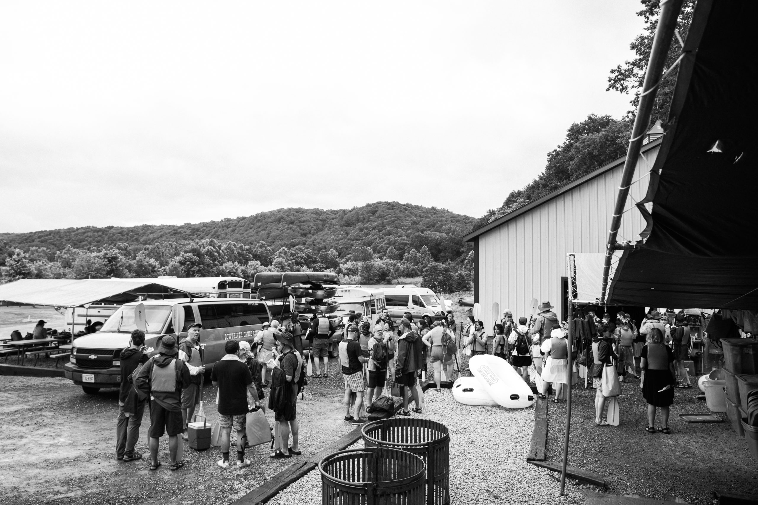 Black and white picture of wedding guests getting ready to go canoeing and kayaking at Low Water Bridge Campground