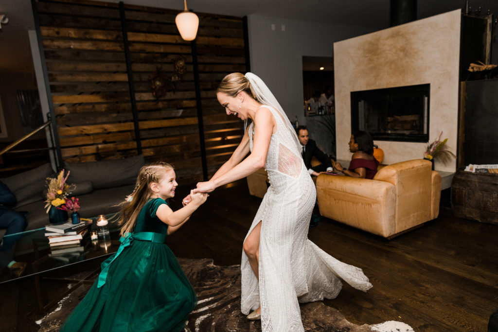 A bride dancing with a little girl