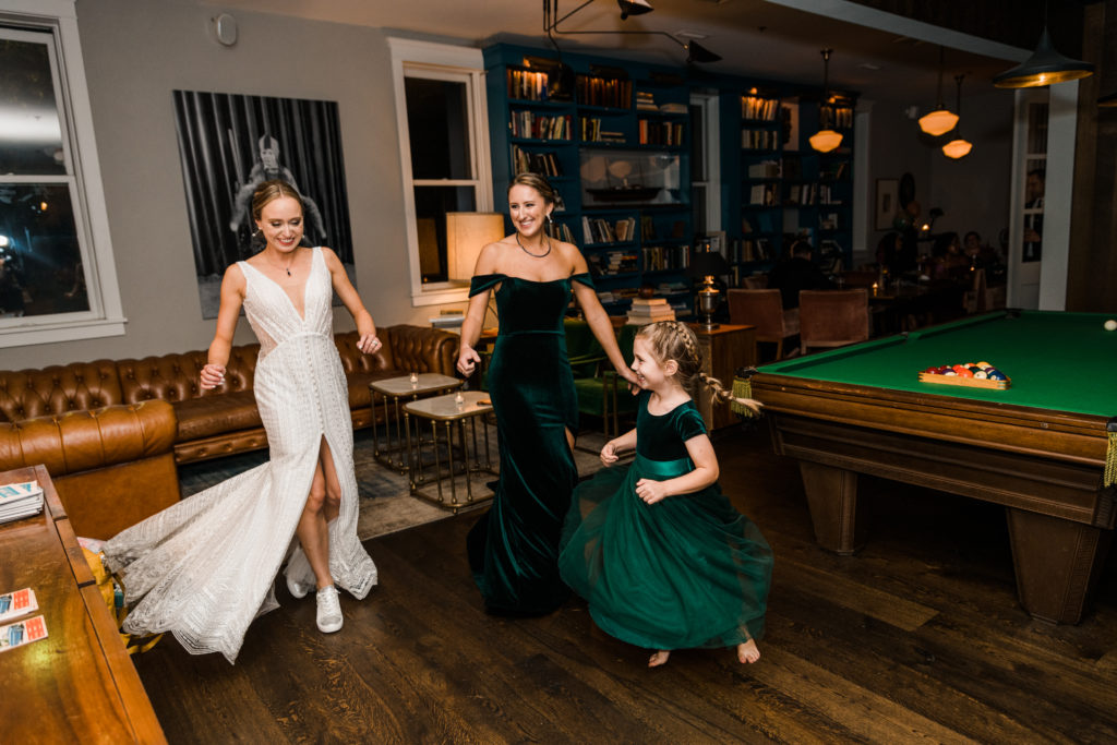 Three people dancing at a wedding