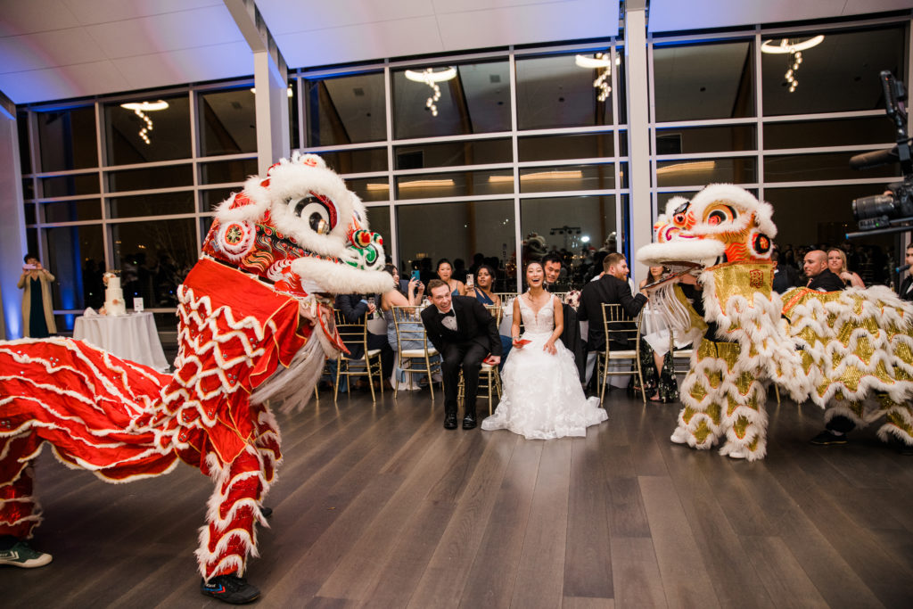 Two Chinese dragons dance at a wedding