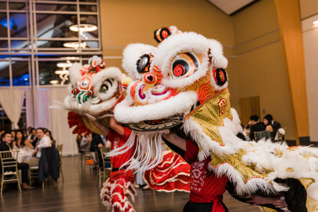 Two Chinese dragons dancing at a wedding reception