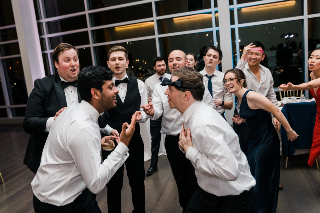 A group of men dance at a wedding reception