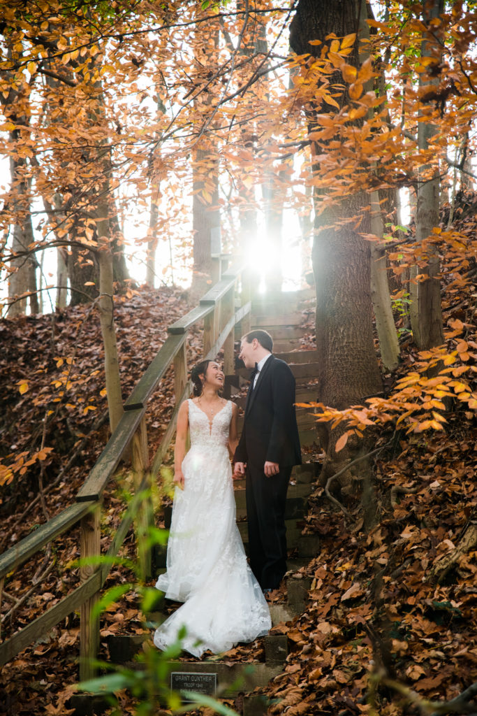 A bride and groom posing in the woods