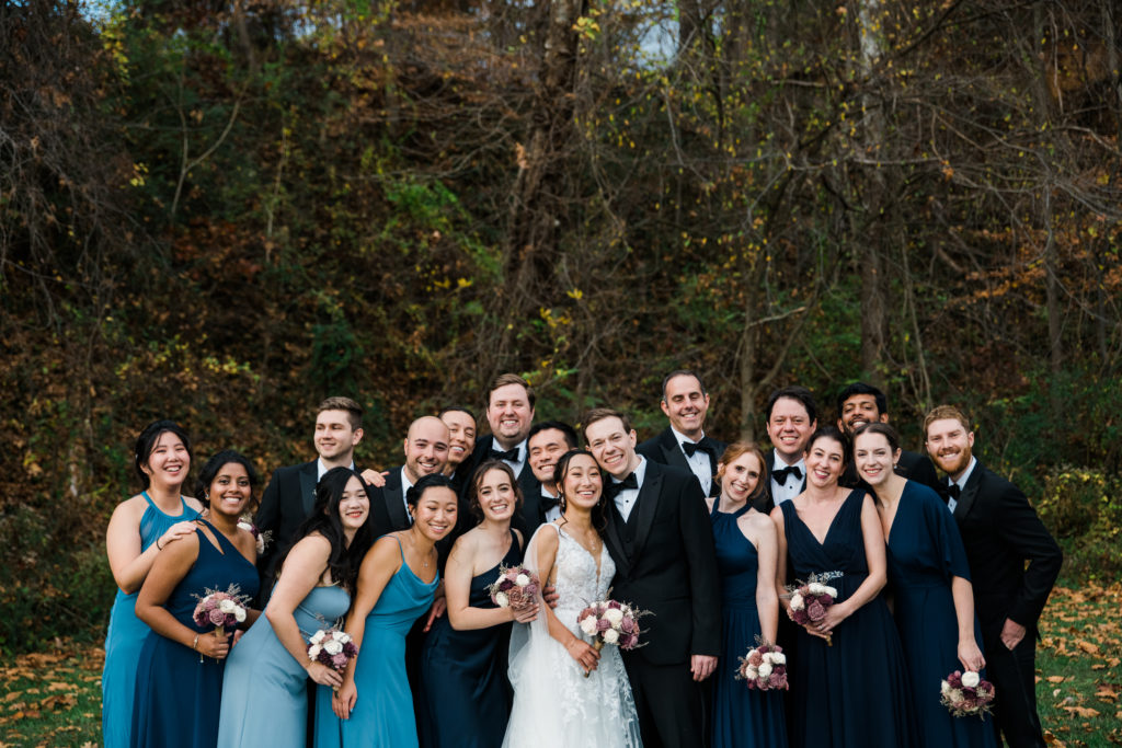 A bride and groom pose with their wedding party