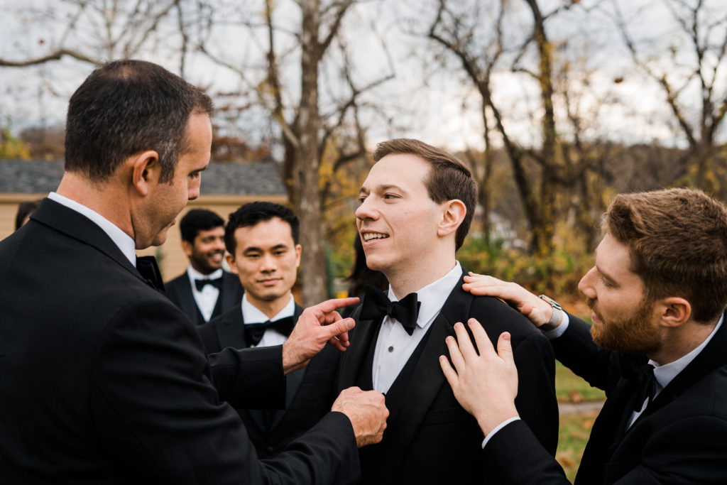 A groom standing with his groomsmen