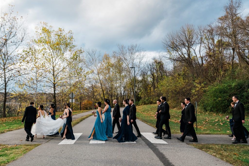 A wedding party walking behind a bride and groom at a wedding