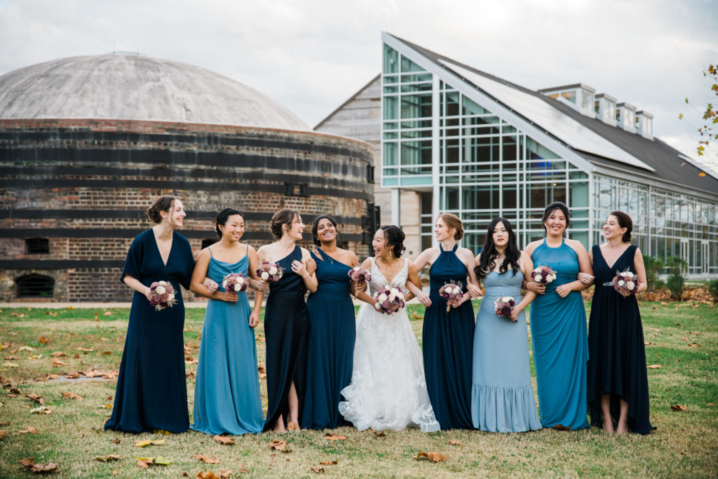 A bride posing in a line with her bridesmaids