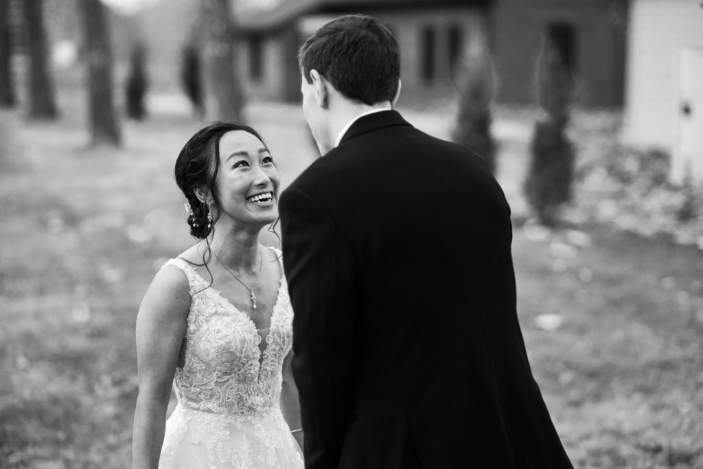 A groom sees the bride in her wedding dress for the first time