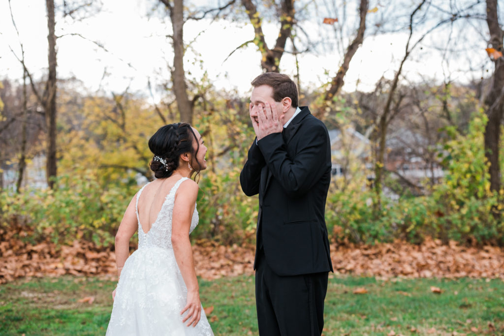 A groom sees the bride in her dress for the first time before their wedding