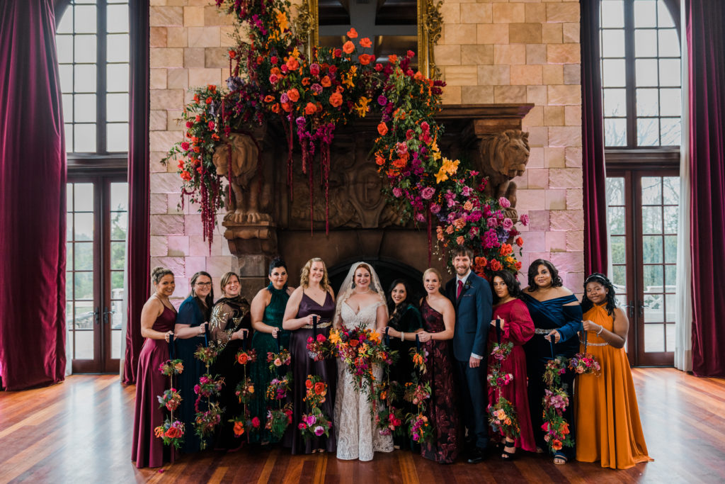 A bride poses with bridesmaids at a wedding