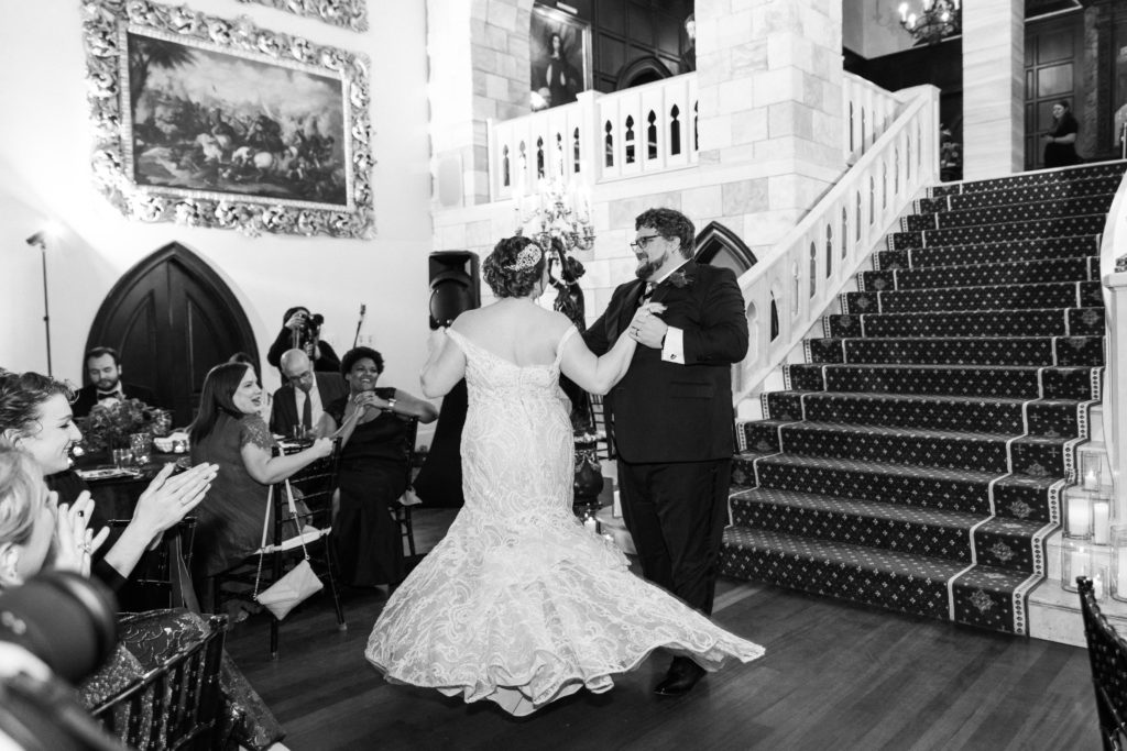 A black and white picture of a bride and groom dancing