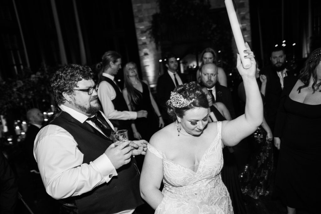 A black and white picture of a bride and groom dancing 