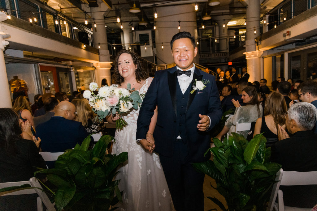 A bride and groom walking down an aisle