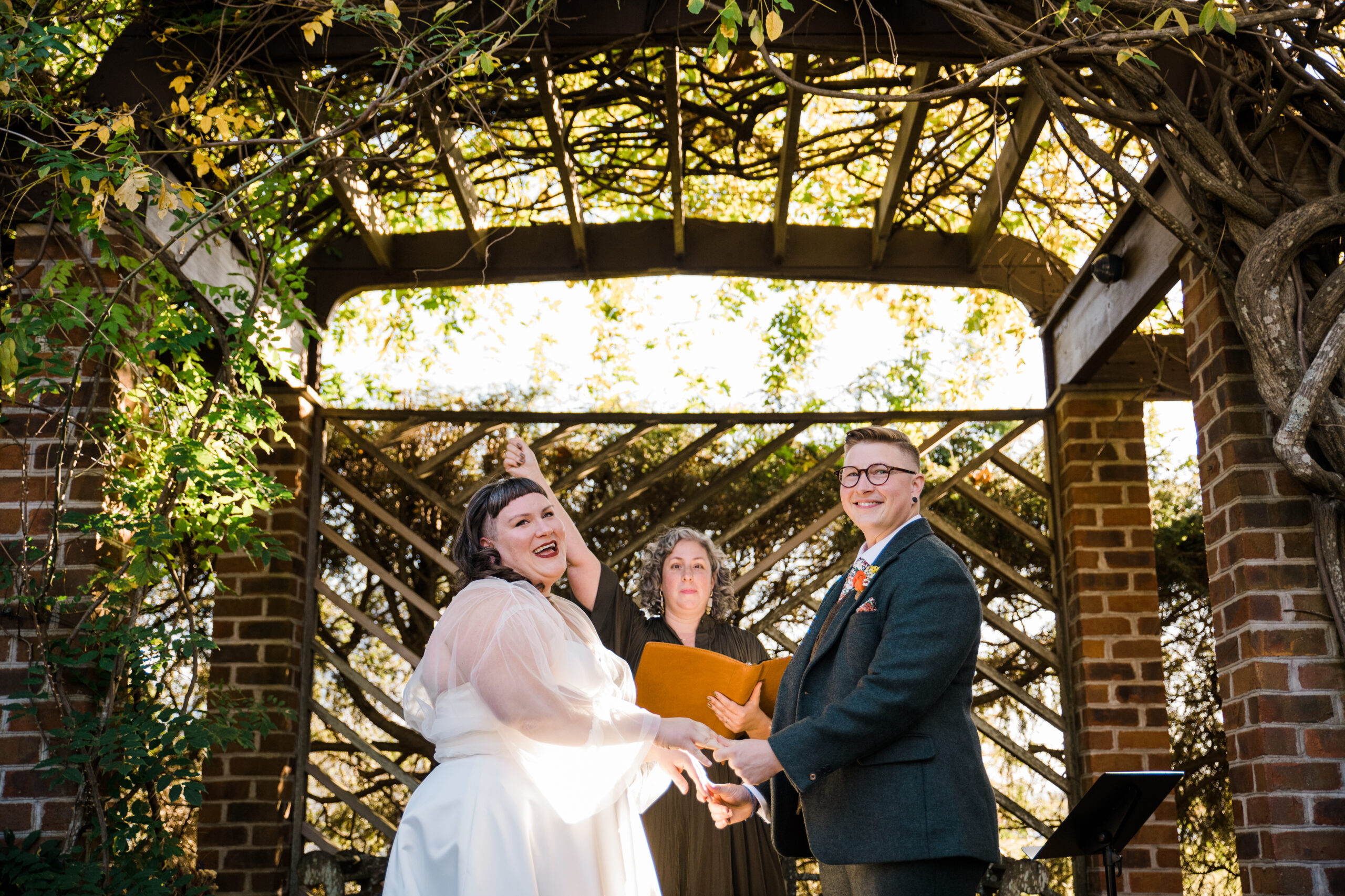 A couple standing at an altar with a wedding officiant