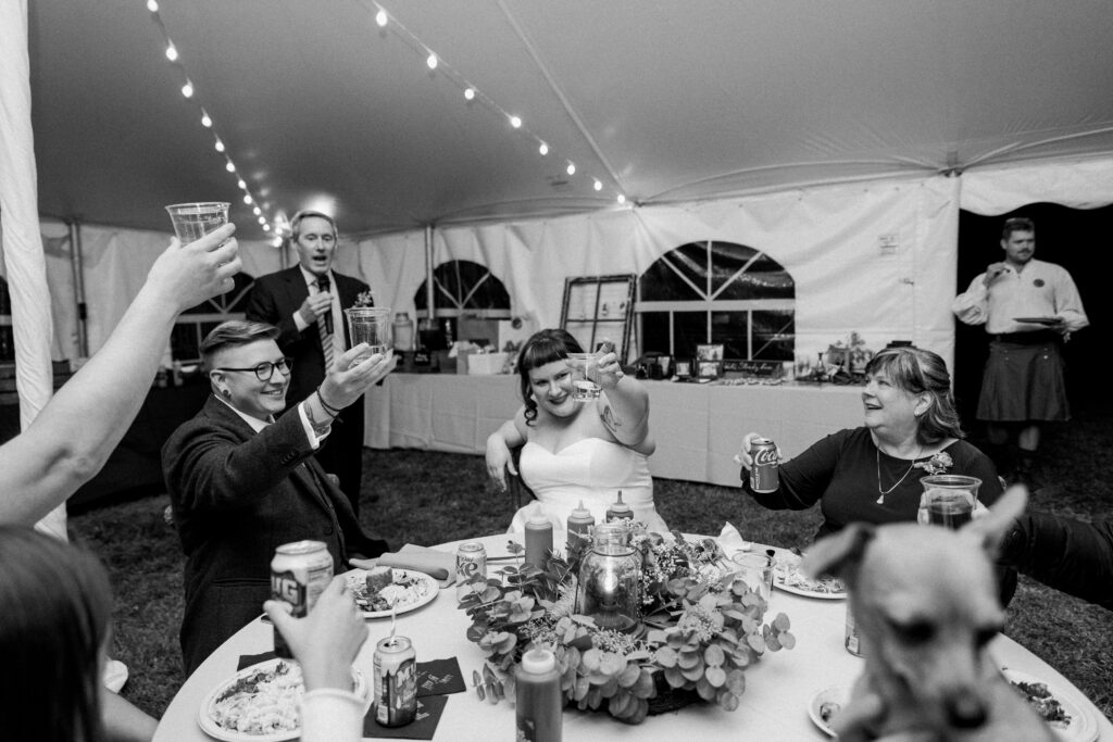 A couple holding up glasses for a toast
