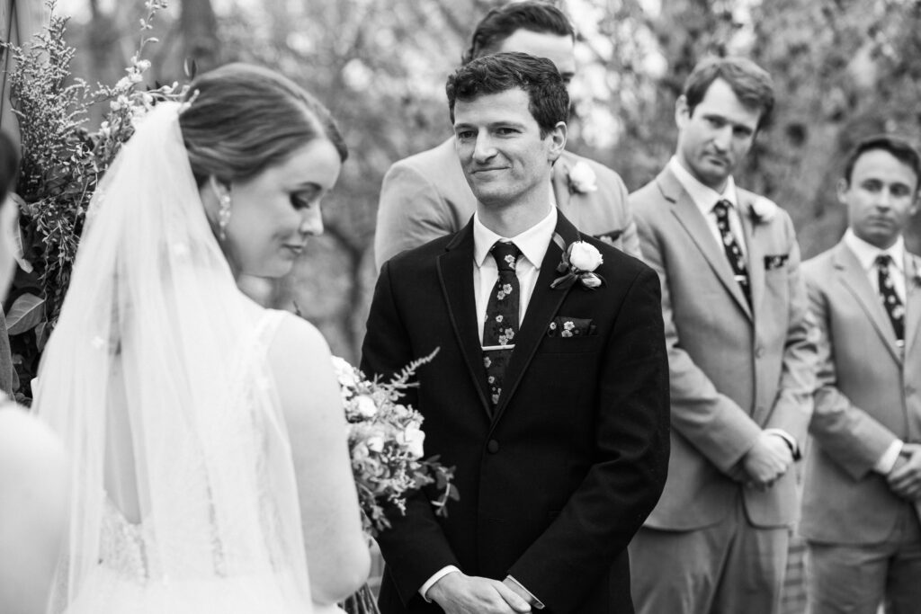 A man in a suit looking at a woman in a wedding dress