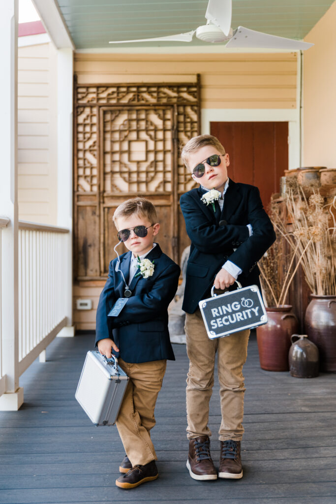 Two boys dressed in suits and wearing sunglasses