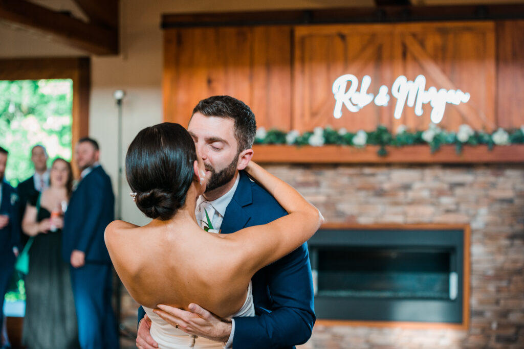 A bride and groom kissing at their wedding reception