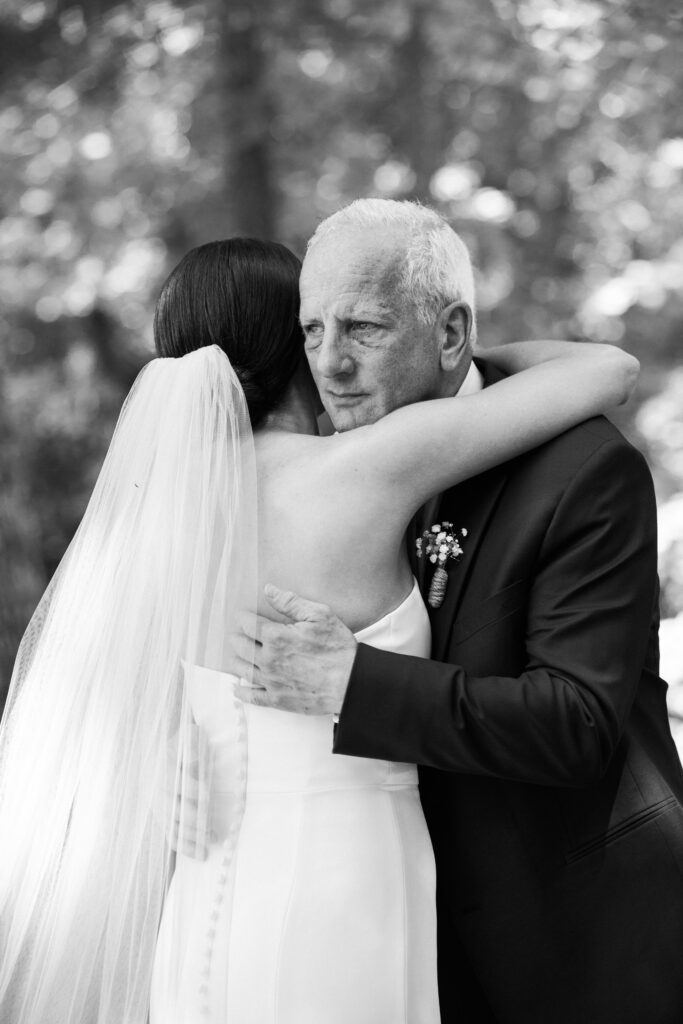 A bride hugging an older gentleman