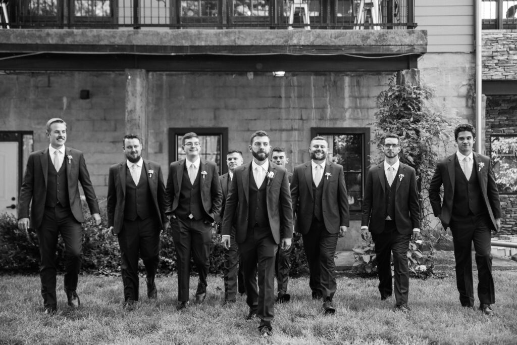 Groomsmen lined up behind a groom at his wedding