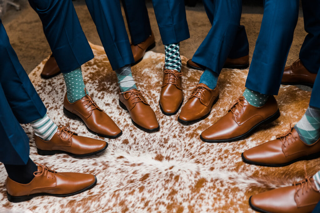 Close up of a group of men's brown dress shoes and teal socks