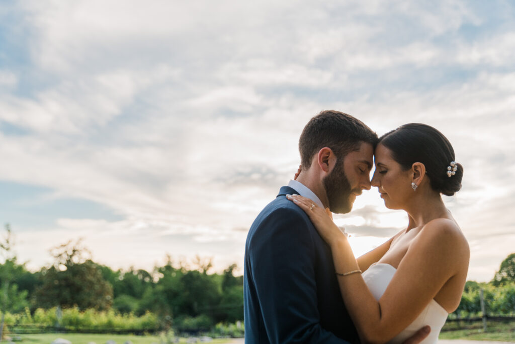 A bride and groom holding each other with their heads next to each other