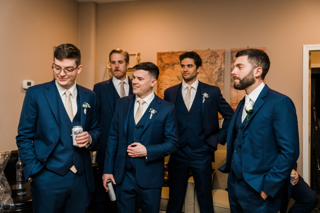 Groomsmen in suits standing together.