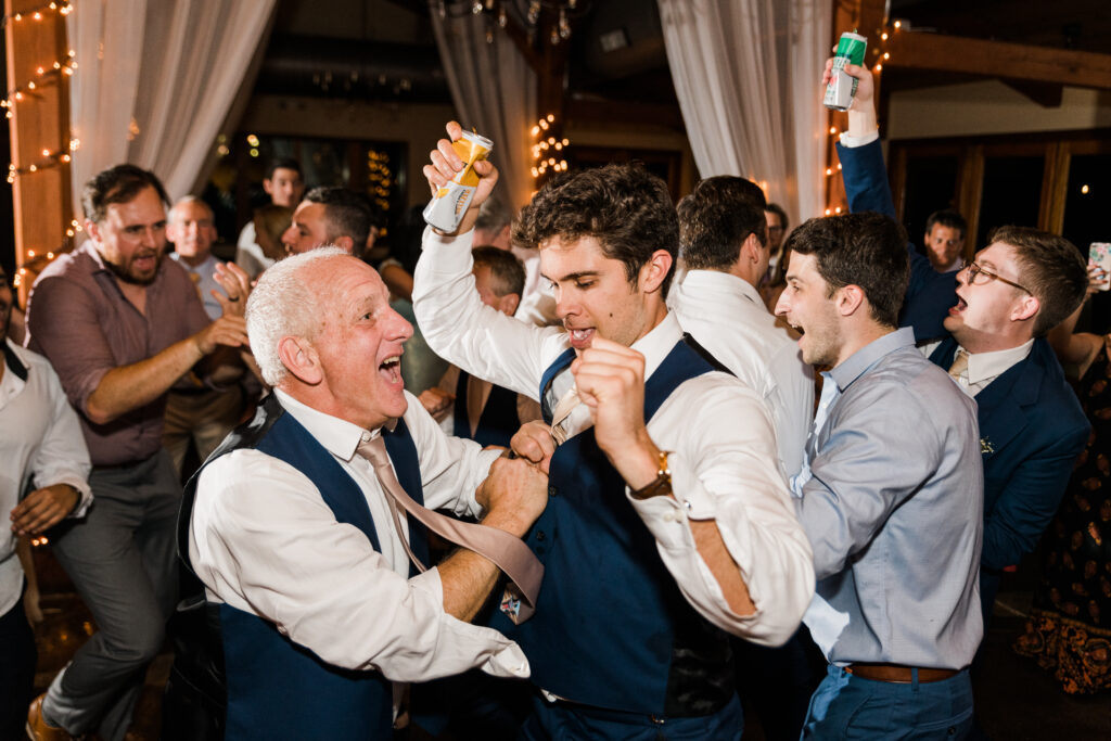 Guests at a wedding reception cheering