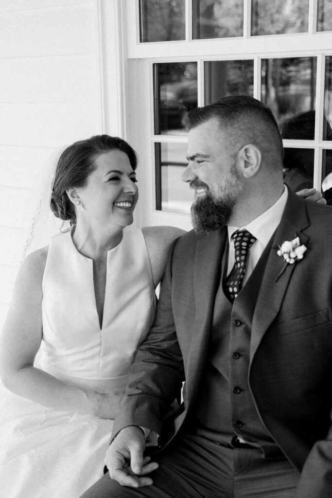 Black and white picture of a bride and groom smiling at each other