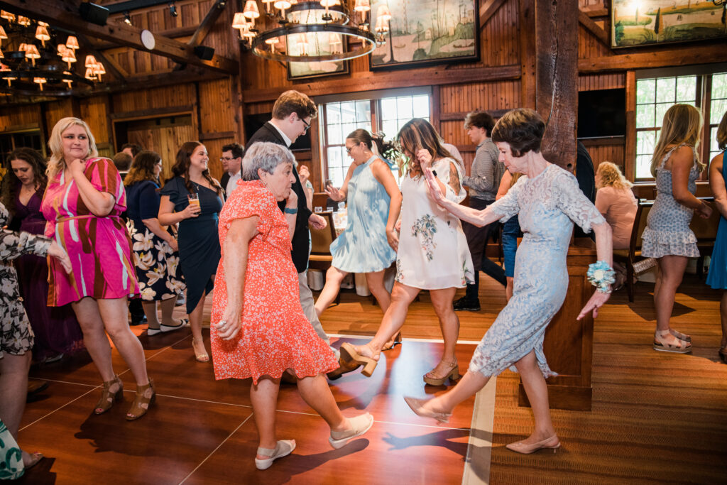 A group of women dancing at a wedding reception