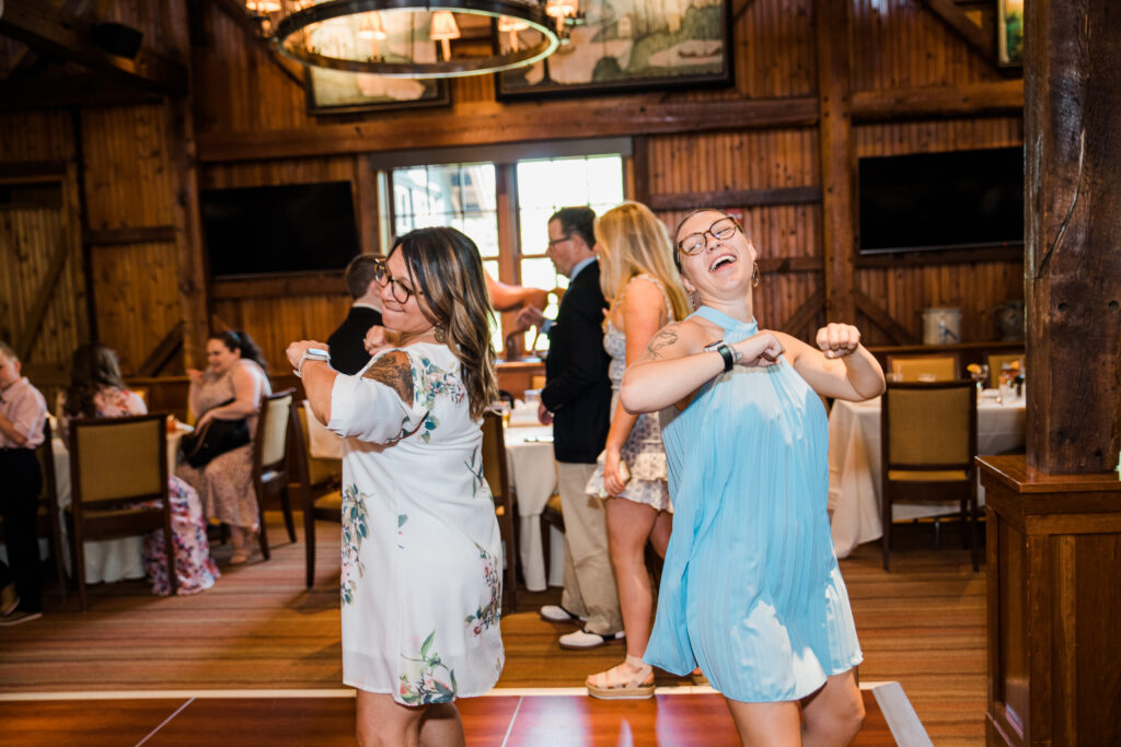 Two women dancing at a wedding reception