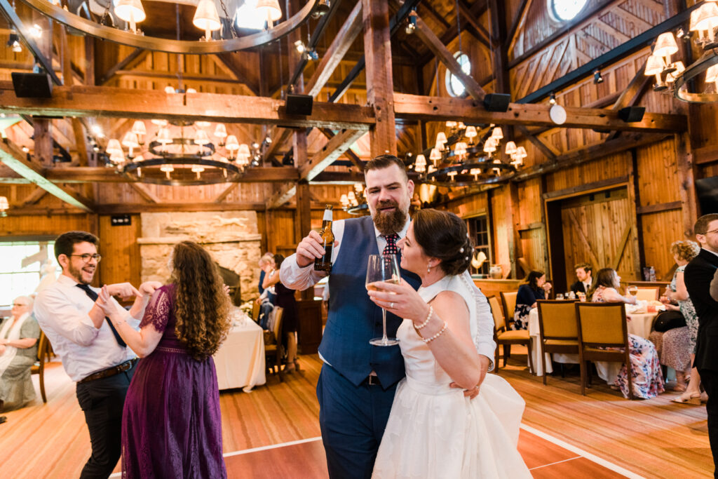 A bride and groom dancing together with another man and woman dancing behind them