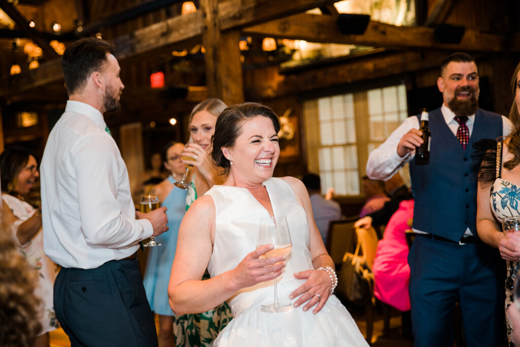 A bride laughing on the dance floor