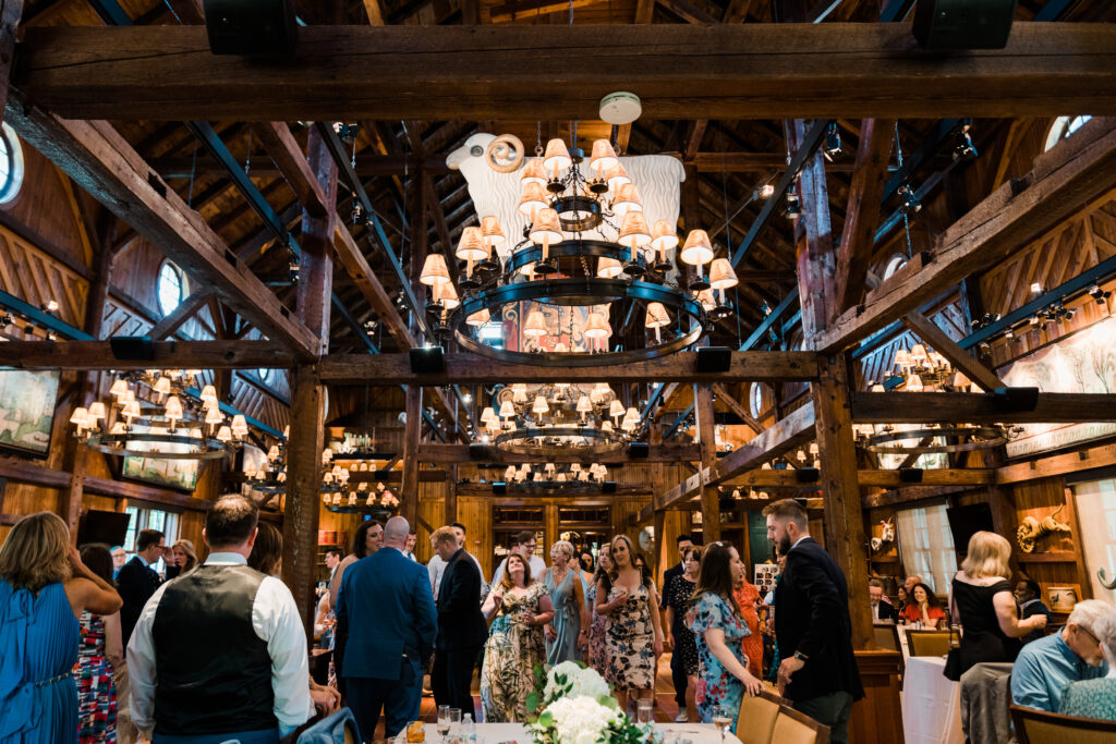 Guests at a wedding reception in a barn