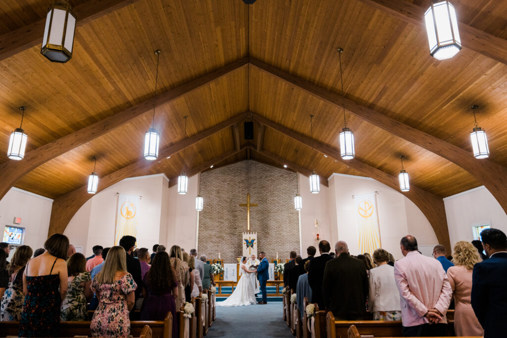 A church with a bride and groom standing at the altar